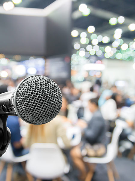 Microphone with abstract blurred photo of conference hall or seminar room with attendee and bokeh Business meeting concept